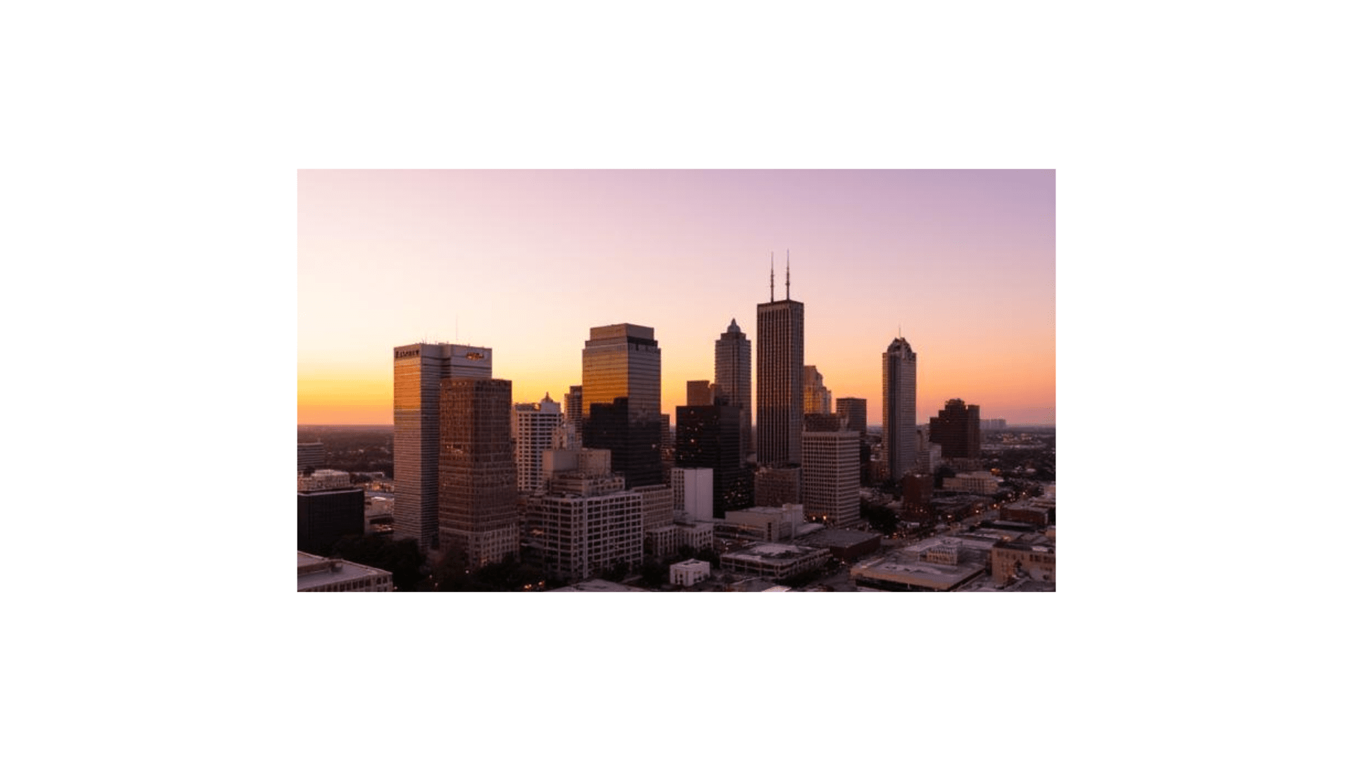 Downtown skyline at sunset representing portfolio scale and market reach